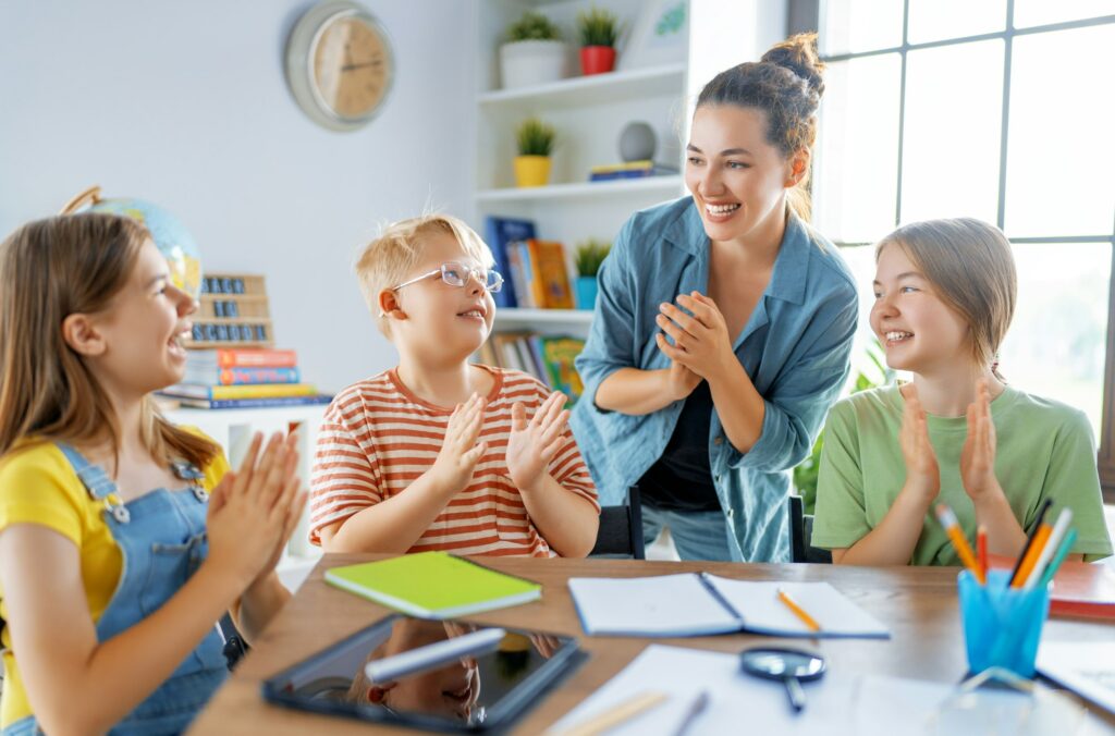 Happy kids and teacher at school